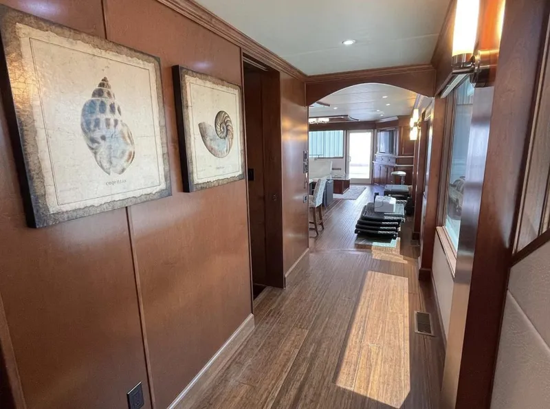 Slide: The Image of Luxurious hallway in 2015 Stardust Cruisers 20' x 106' houseboat with wooden decor. - 11