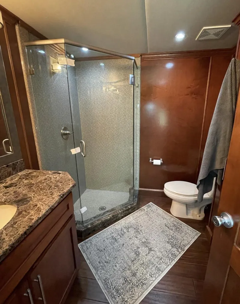Slide: The Image of Luxurious bathroom in 2015 Stardust Cruisers 20' x 106' houseboat with glass shower. - 17