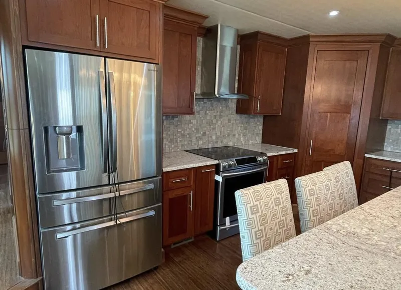 Slide: The Image of Modern kitchen in 2015 Stardust Cruisers houseboat with stainless steel appliances and granite countertops. - 21