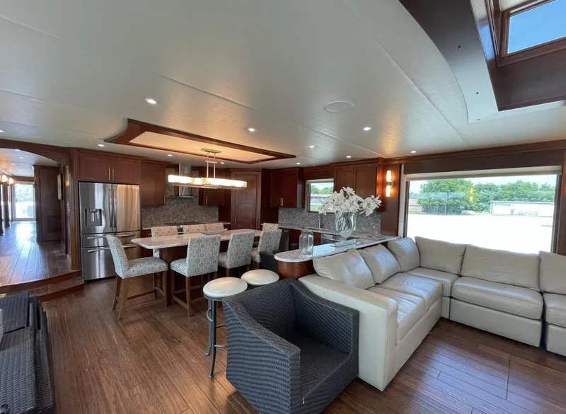 Slide: The Image of Luxurious interior of 2015 Stardust Cruisers 20' x 106' houseboat with modern kitchen and living area. - 22