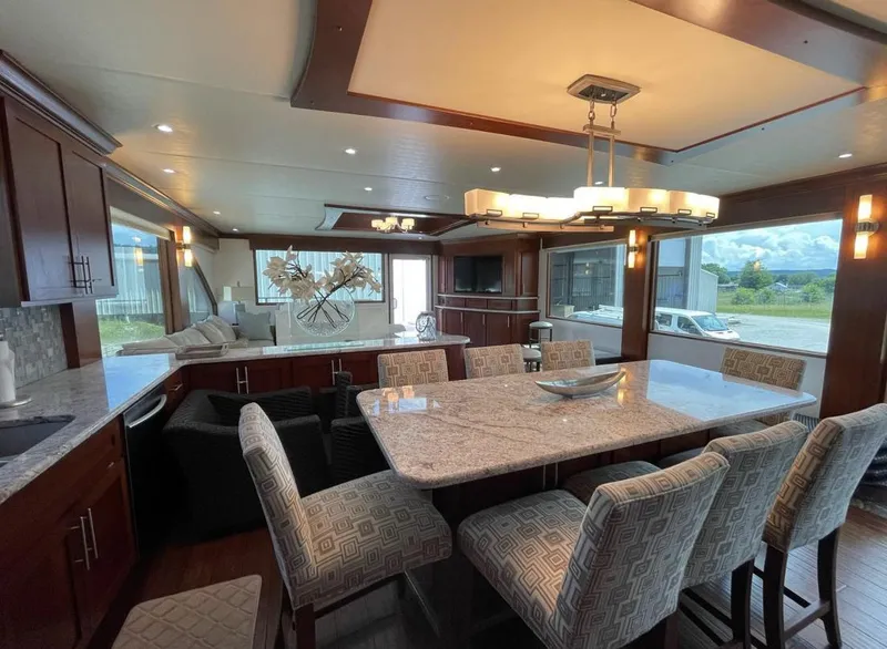 Slide: The Image of Luxurious interior of 2015 Stardust Cruisers 20' x 106' houseboat with modern dining area. - 25