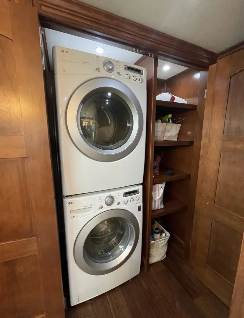 Slide: The Image of Stacked washer and dryer in wooden closet on Stardust Cruisers houseboat. - 5