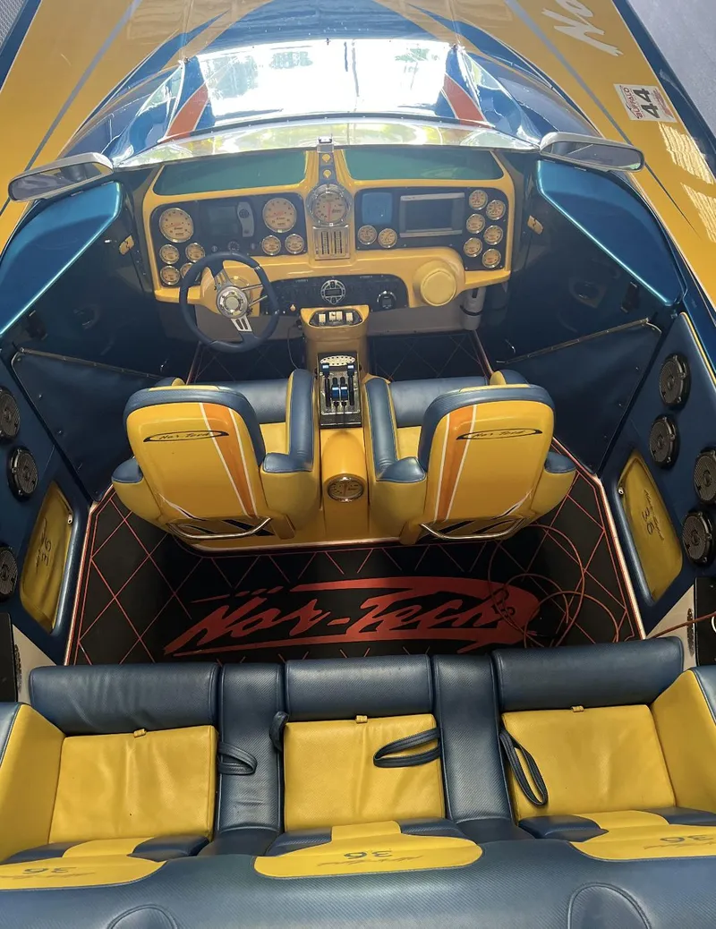 Slide: The Image of 2007 Nor-Tech 3600 Supercat boat interior with yellow and black seats and dashboard. - 6