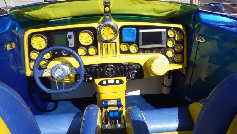 Slide: The Image of 2007 Nor-Tech 3600 Supercat boat dashboard with vibrant yellow and blue controls. - 7