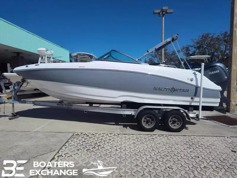 Slide: The Image of 2024 NauticStar 223 DC boat on trailer at Boaters Exchange dealership. - 1
