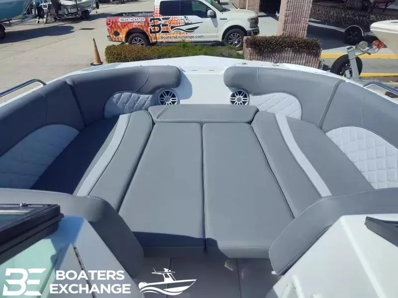 Slide: The Image of 2024 NauticStar 223 DC boat interior with gray seating and speakers, displayed at Boaters Exchange. - 10