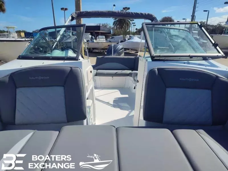 Slide: The Image of 2024 NauticStar 223 DC boat interior with seating, windshield, and Boaters Exchange logo. - 11