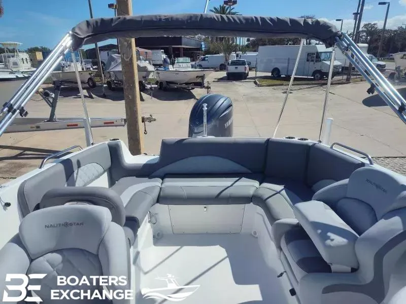 Slide: The Image of 2024 NauticStar 223 DC boat interior with gray seating and canopy at Boaters Exchange. - 3
