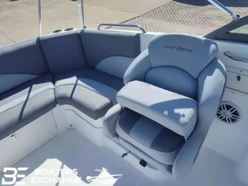 Slide: The Image of 2024 NauticStar 223 DC boat interior with gray seating and Boaters Exchange logo. - 4