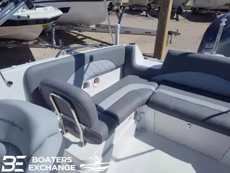 Slide: The Image of 2024 NauticStar 223 DC boat interior with gray seating and Boaters Exchange logo. - 5