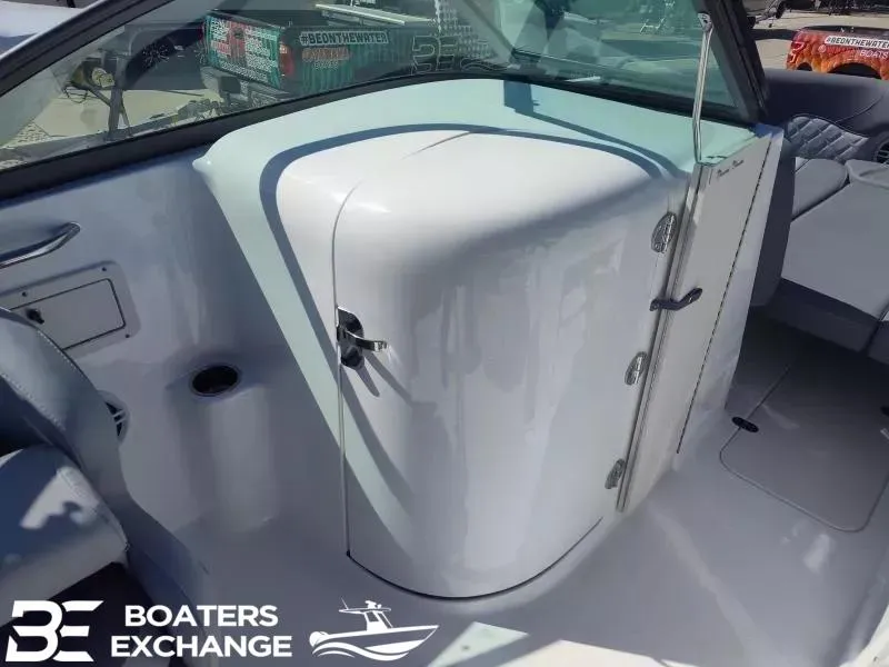 Slide: The Image of 2024 NauticStar 223 DC boat interior with seating and storage compartment. - 8