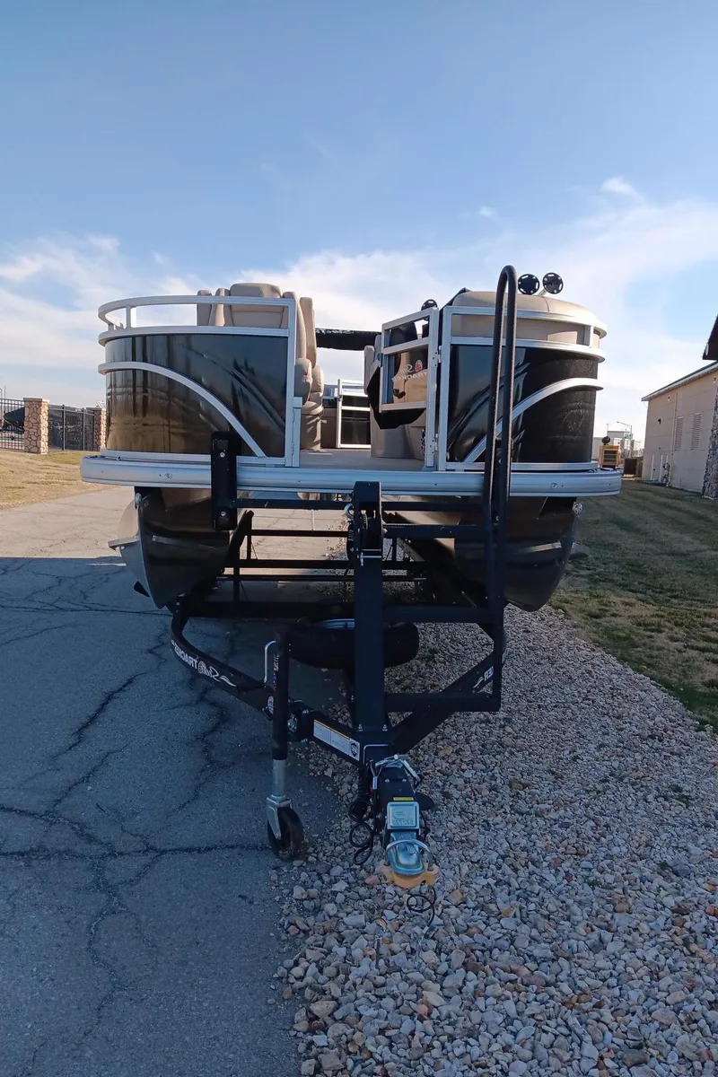 Slide: The Image of 2024 Sun Tracker SportFish 20 DLX pontoon boat on trailer. - 3