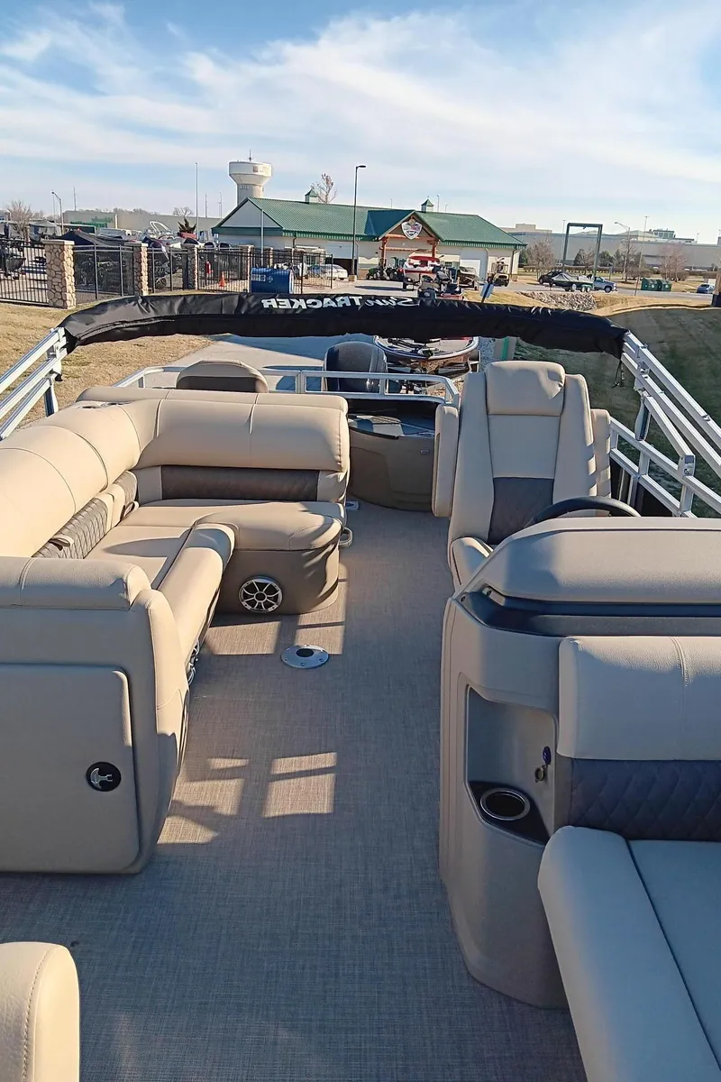 Slide: The Image of 2024 Sun Tracker SportFish 20 DLX pontoon boat with beige seating. - 4