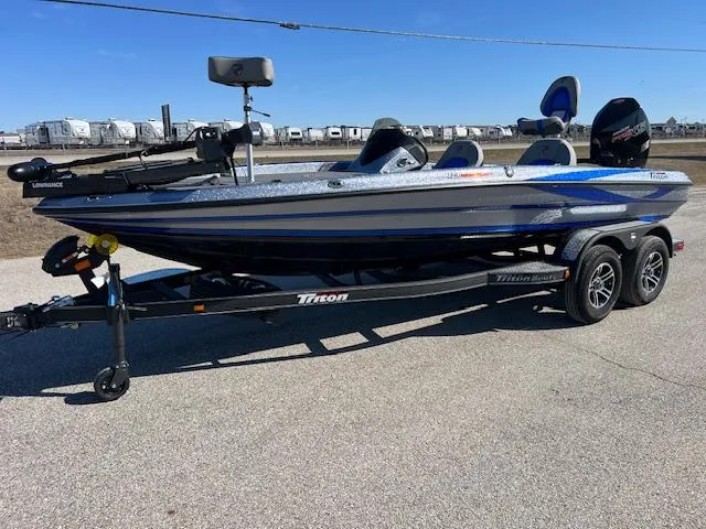 Slide: The Image of 2024 Triton 19 TrX Patriot fishing boat on trailer, blue and white. - 3