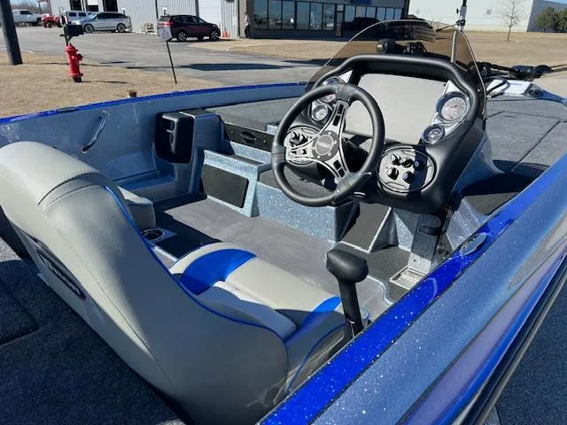 Slide: The Image of 2024 Triton 19 TrX Patriot boat interior with steering wheel and dashboard. - 5