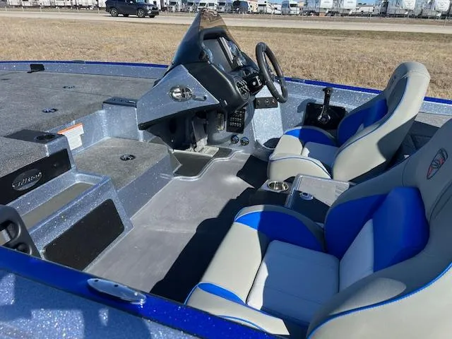 Slide: The Image of 2024 Triton 19 TrX Patriot boat interior with blue and gray seats. - 6