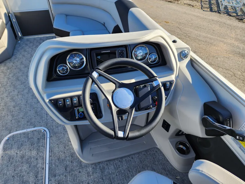 Slide: The Image of 2024 Trifecta 24RF LE 2 75 boat dashboard with steering wheel and controls. - 16