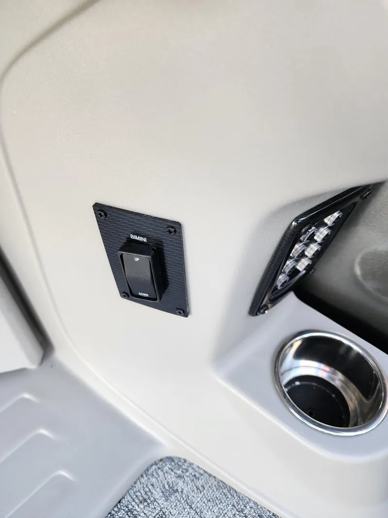 Slide: The Image of Interior detail of 2024 Trifecta 24RF LE 2 75 w trailer, featuring switch and cup holder. - 19