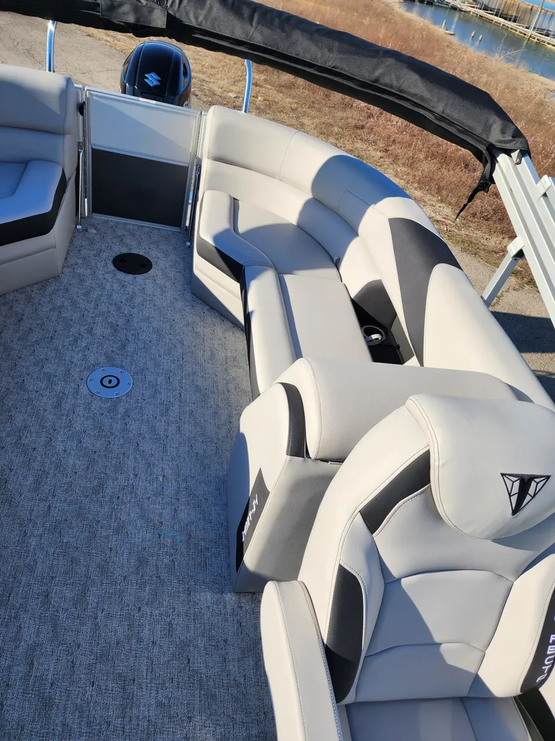 Slide: The Image of 2024 Trifecta 24RF LE 2 75 pontoon boat interior with trailer. - 20