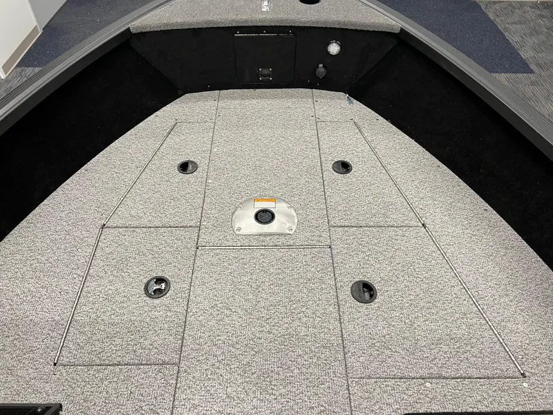 Slide: The Image of 2023 Alumacraft Competitor 175 Sport boat interior with carpeted deck and storage compartments. - 13
