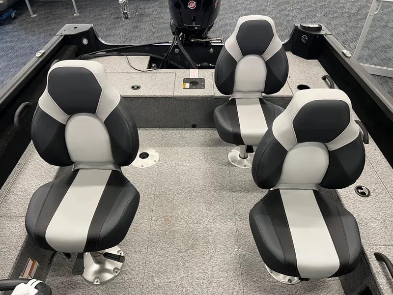 Slide: The Image of 2023 Alumacraft Competitor 175 Sport boat interior with three black and gray seats. - 18