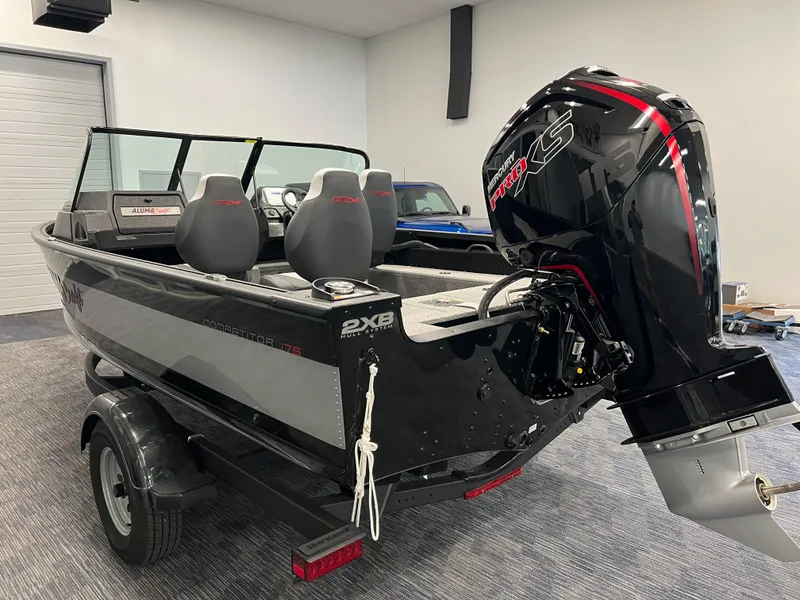 Slide: The Image of 2023 Alumacraft Competitor 175 Sport boat with powerful outboard motor in showroom. - 3