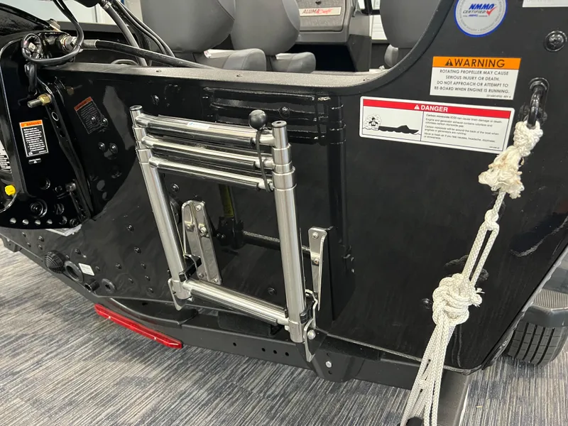 Slide: The Image of 2023 Alumacraft Competitor 175 Sport boat ladder and safety warnings. - 4