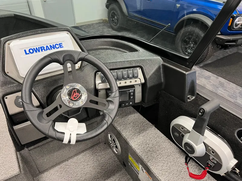 Slide: The Image of 2023 Alumacraft Competitor 175 Sport dashboard with Lowrance system and steering wheel. - 9