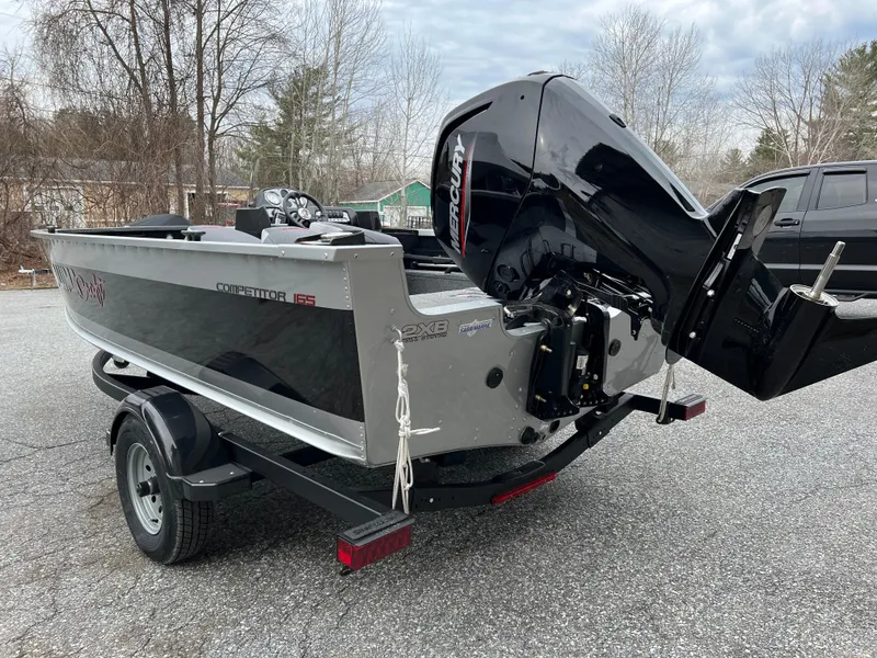 Slide: The Image of 2023 Alumacraft Competitor 165 SC boat with Mercury outboard motor on trailer. - 2