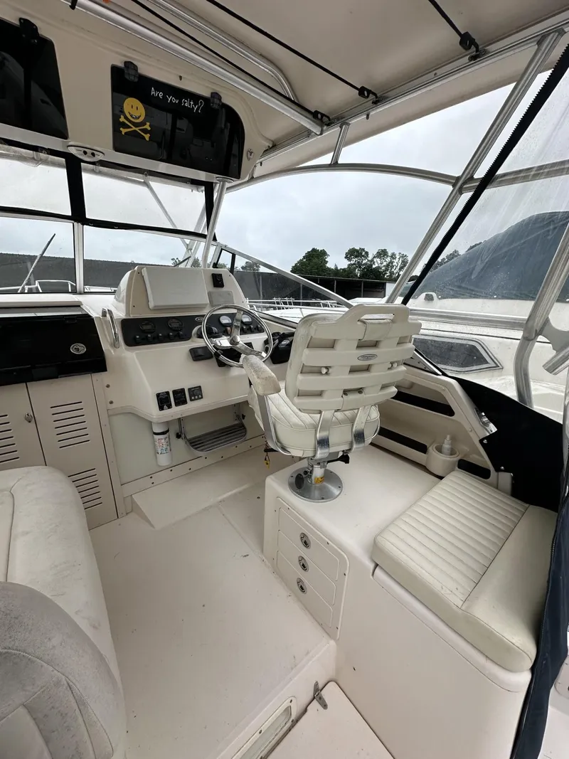 Slide: The Image of 2005 Grady-White Marlin 300 boat cockpit with steering wheel and seating. - 11