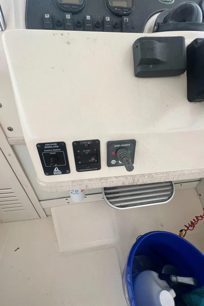 Slide: The Image of Control panel of 2005 Grady-White Marlin 300 boat with switches and bucket. - 16
