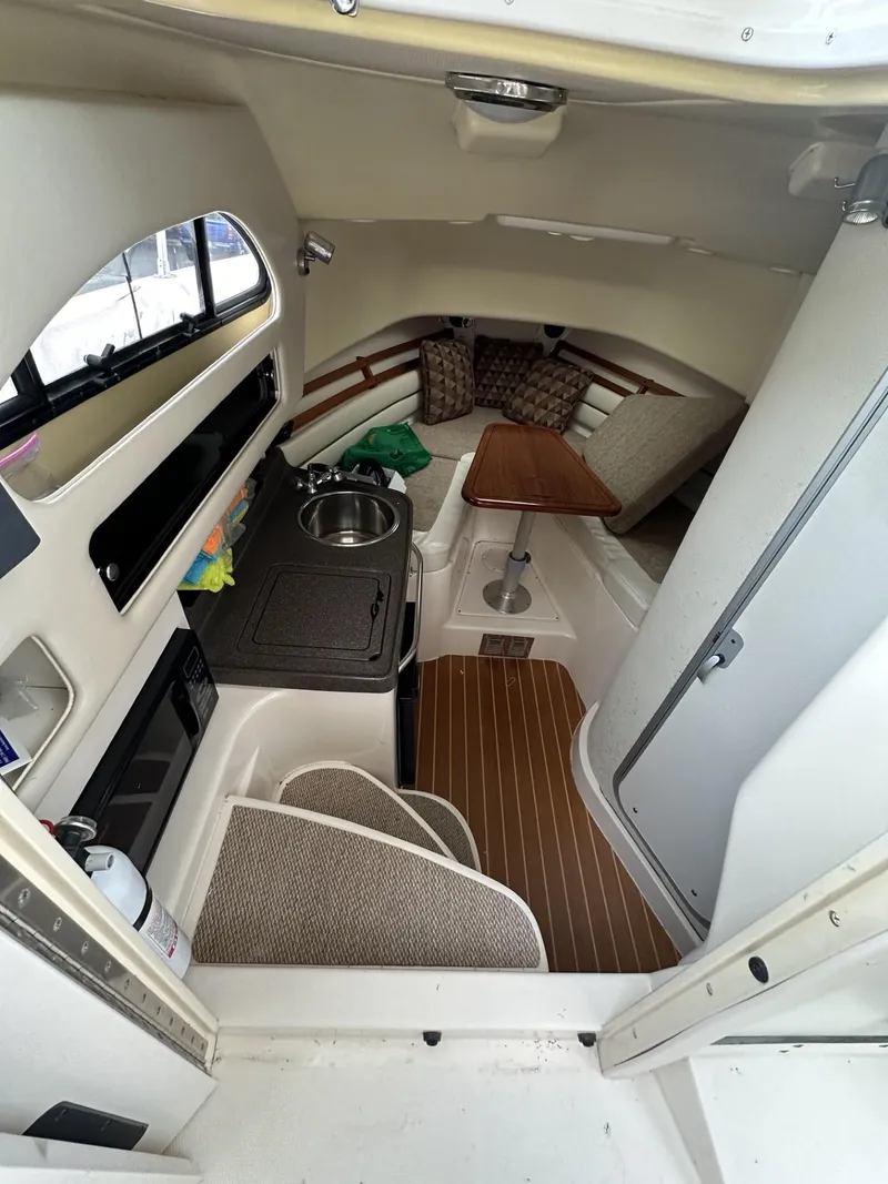Slide: The Image of 2005 Grady-White Marlin 300 cabin interior with kitchenette and seating area. - 17