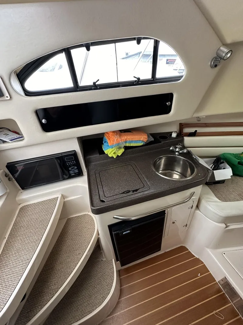 Slide: The Image of 2005 Grady-White Marlin 300 boat interior with kitchenette and stairs. - 18