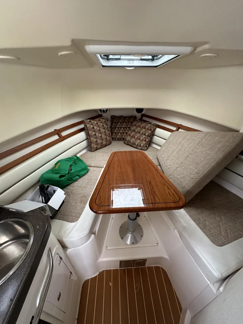 Slide: The Image of 2005 Grady-White Marlin 300 cabin interior with seating, table, and skylight. - 19