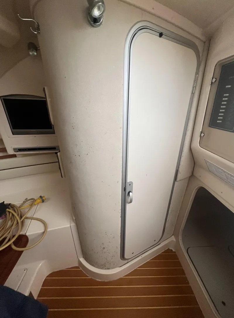 Slide: The Image of Interior cabin of 2005 Grady-White Marlin 300 boat with wooden flooring. - 21