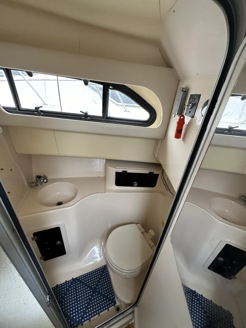 Slide: The Image of 2005 Grady-White Marlin 300 boat bathroom interior with sink and toilet. - 22