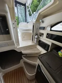 Slide: The Image of 2005 Grady-White Marlin 300 cabin interior with steps and seating area. - 23