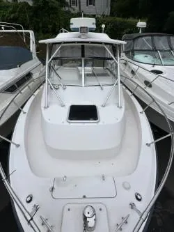 Slide: The Image of 2005 Grady-White Marlin 300 boat docked among other vessels. - 25