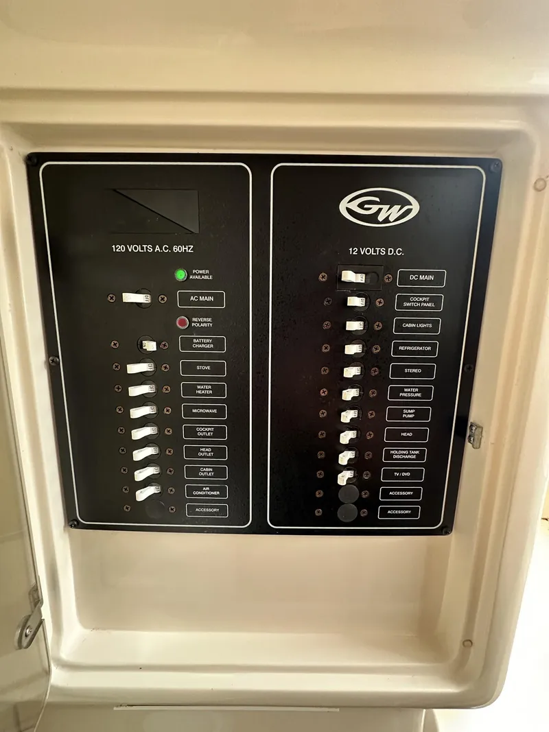 Slide: The Image of Electrical panel of 2005 Grady-White Marlin 300 boat, showing AC and DC switches. - 28