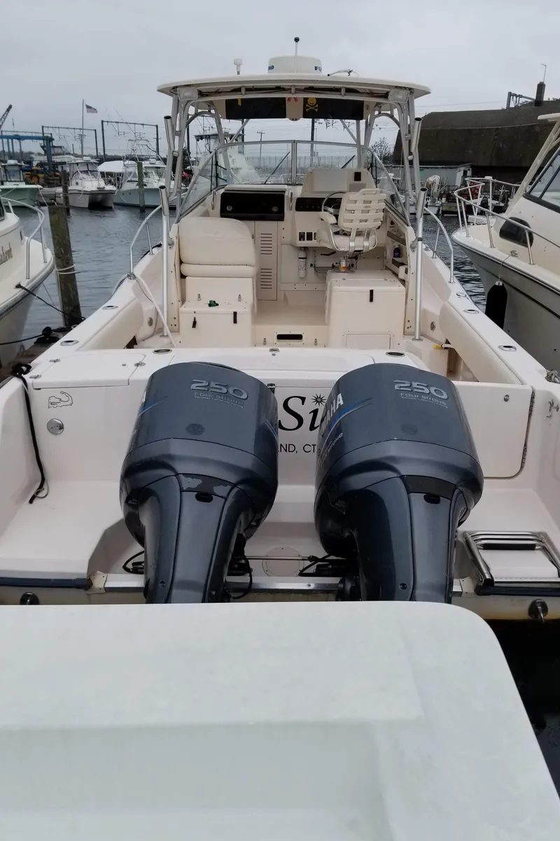 Slide: The Image of 2005 Grady-White Marlin 300 boat with twin 250 engines docked at marina. - 3