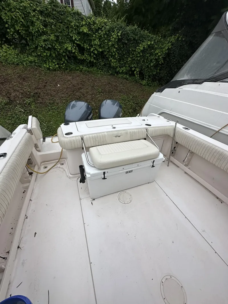 Slide: The Image of 2005 Grady-White Marlin 300 boat interior with seating and twin engines. - 6