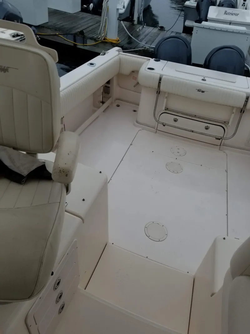Slide: The Image of 2005 Grady-White Marlin 300 boat interior with seating and storage compartments. - 7