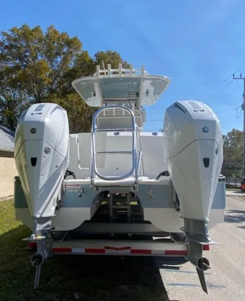 Slide: The Image of 2024 World Cat 280 CC-X boat with dual outboard engines on a trailer. - 3
