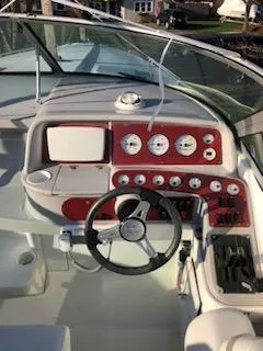 Slide: The Image of Cockpit of a 2000 Formula 33SS boat with red dashboard and steering wheel. - 1