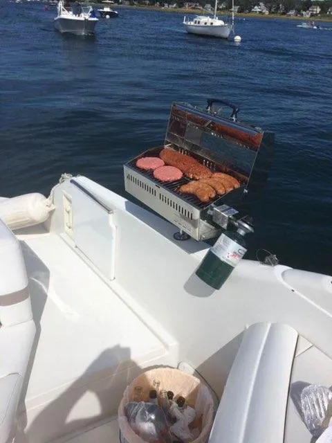 Slide: The Image of Grilling burgers on a 2000 Formula 33SS boat on a sunny day. - 5