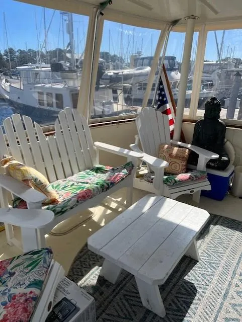Slide: The Image of 1971 Hatteras 43 Double Cabin interior with white Adirondack chairs and nautical decor. - 10