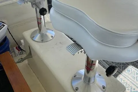 Slide: The Image of Captain's chairs on a 1971 Hatteras 43 Double Cabin yacht, featuring white upholstery and metal pedestals. - 11