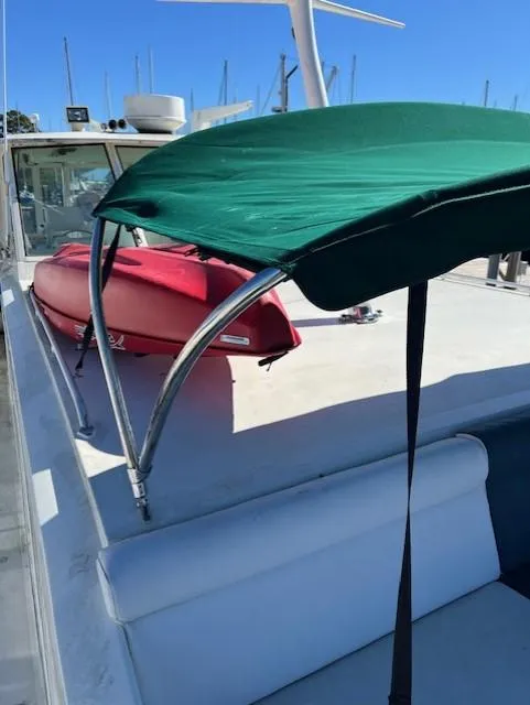 Slide: The Image of 1971 Hatteras 43 Double Cabin with green canopy and red kayak on deck. - 15