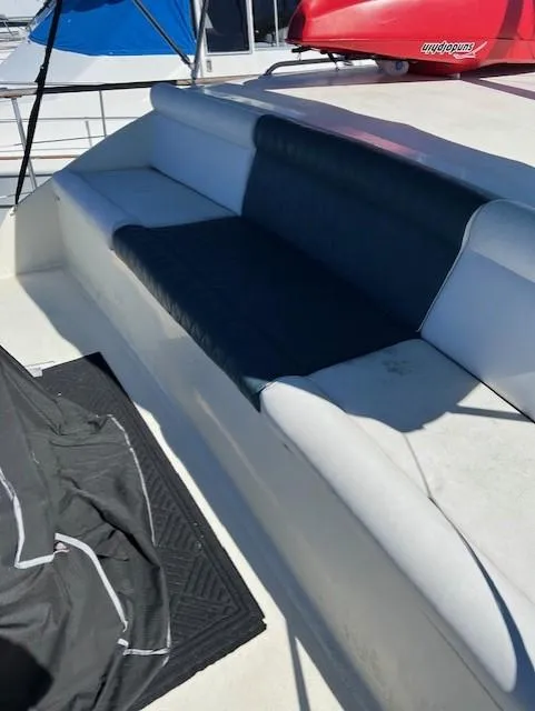Slide: The Image of 1971 Hatteras 43 Double Cabin boat seating area with blue and white cushions. - 17