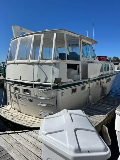 Slide: The Image of 1971 Hatteras 43 Double Cabin yacht docked under clear blue sky. - 2